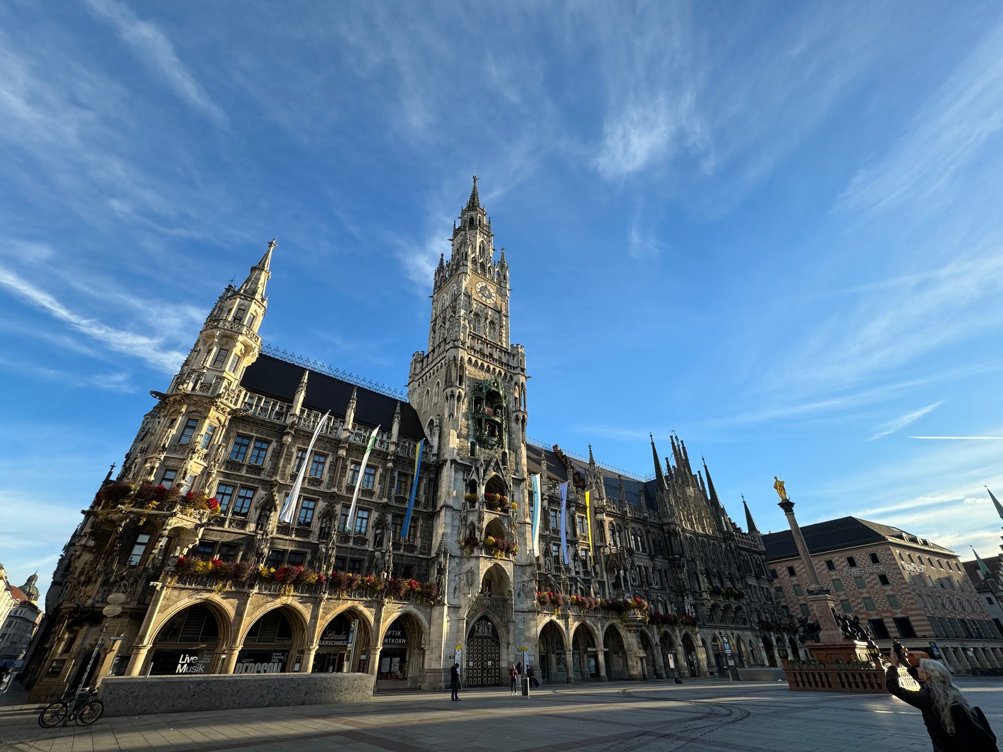 早朝のミュンヘン・マリエン広場。ゴシック様式の新市庁舎（Neues Rathaus）と青空